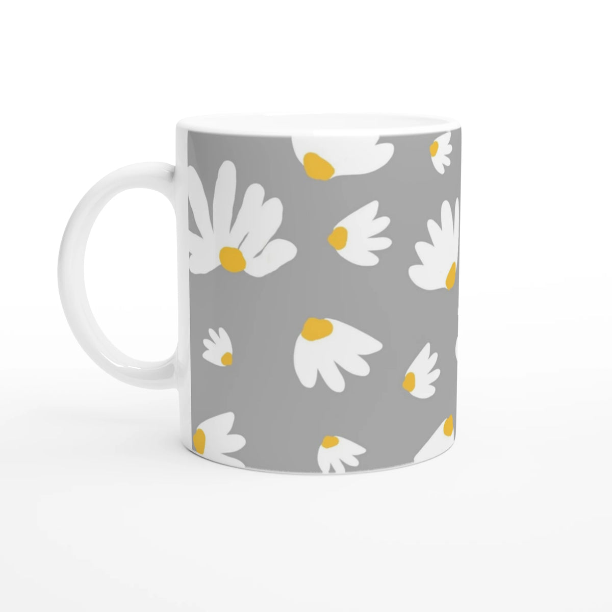 Ditsy Daisy mug with white daisies and yellow centers on gray ceramic.