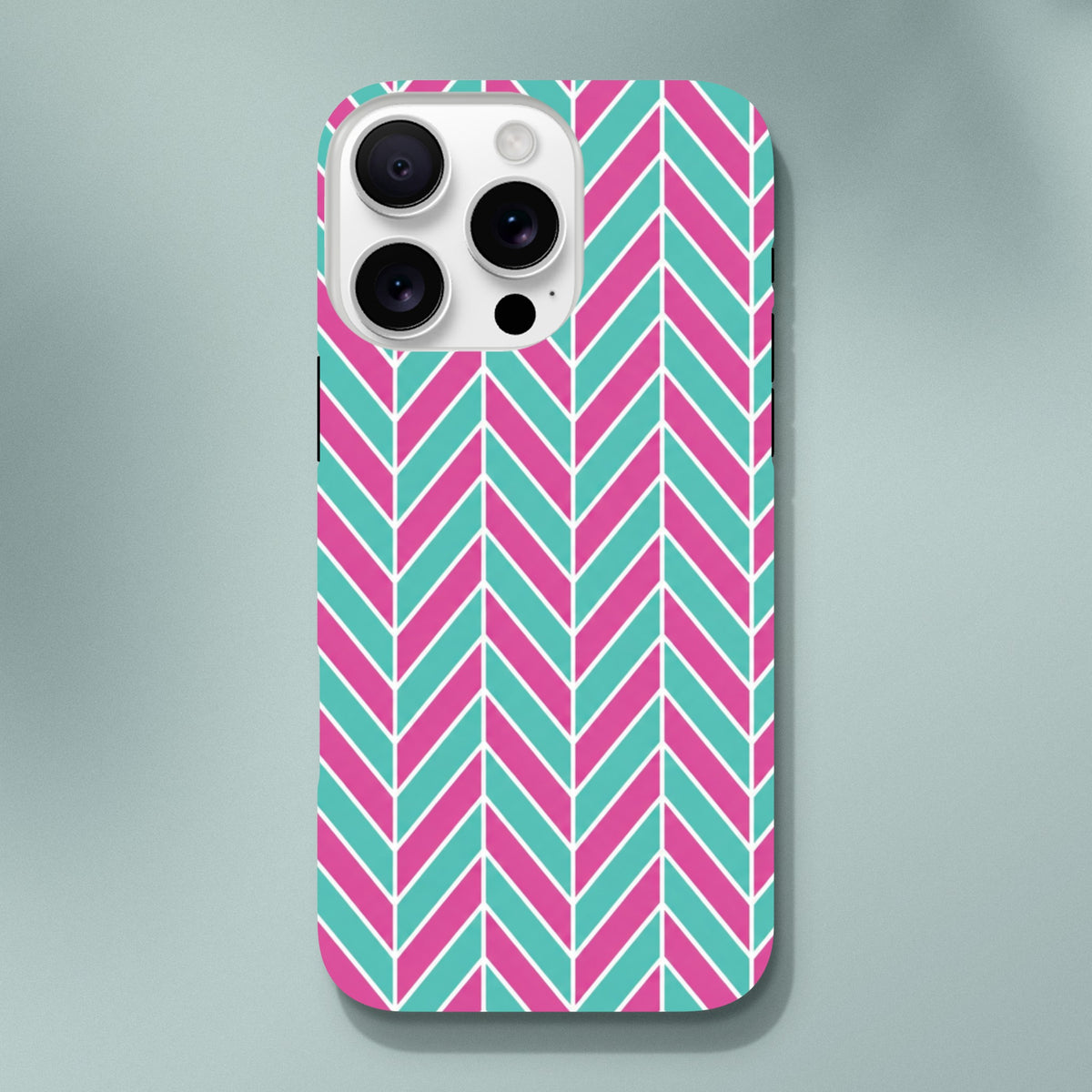 Pink and turquoise herringbone iPhone case with geometric chevron pattern and glossy finish for shock absorption.