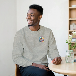 Man smiling in a grey long sleeve sweatshirt featuring a colorful Urban Palm Trees Full Send pocket logo.