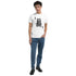Male model wearing white King graphic T-shirt with crowned skull design in soft cotton blend, crew neck