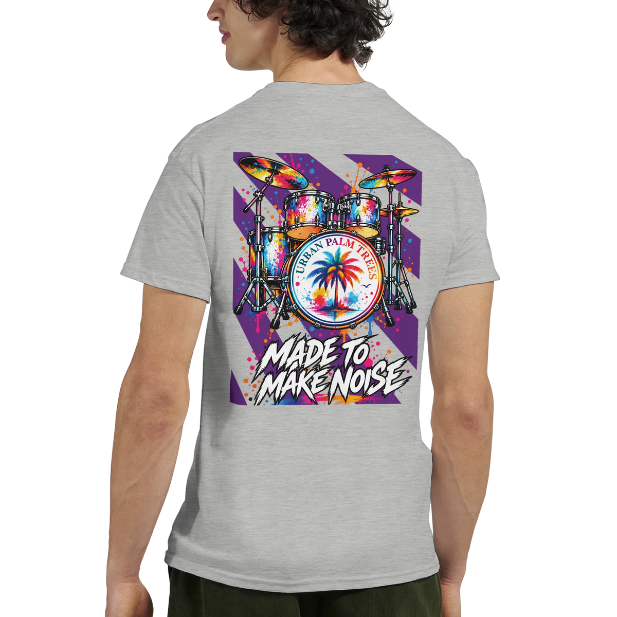 Gray t-shirt back print featuring a colorful retro drum kit with splatter art, palm tree logo, and "Made To Make Noise" text.