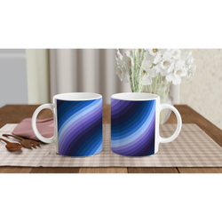 Blue Retro Wave Mugs with abstract Y2K swirl ceramic design on a table beside flowers.