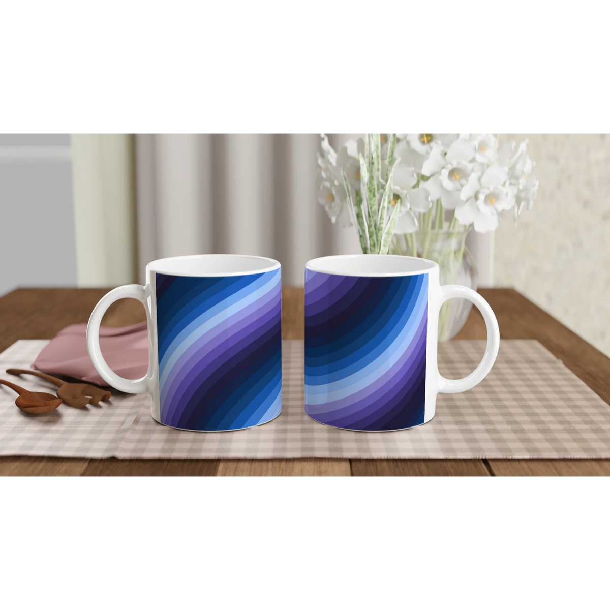 Blue Retro Wave Mugs with abstract Y2K swirl ceramic design on a table beside flowers.