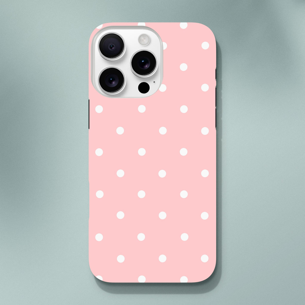 Pastel pink iPhone case with white polka dots. Cute tough protective cover featuring shock-absorbing TPU and dual-layer frame for dropped phones.