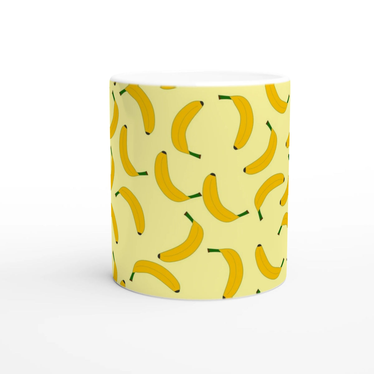 Cute banana-pattern mug on pale yellow with yellow bananas and green stems.