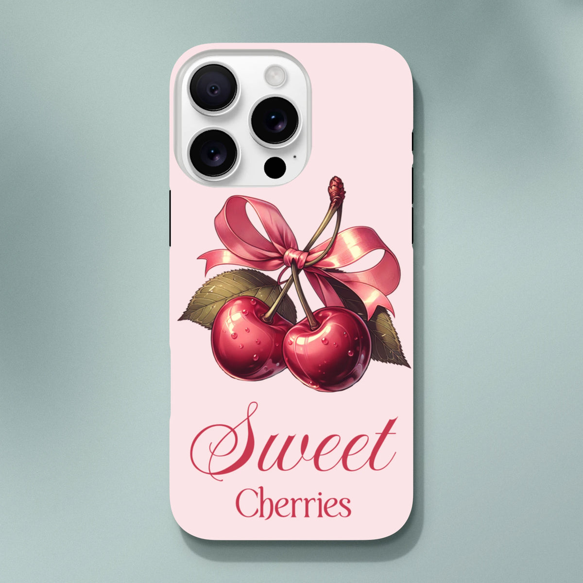 Pink iPhone case featuring retro red cherries tied with a vintage bow and "Sweet Cherries" script text.