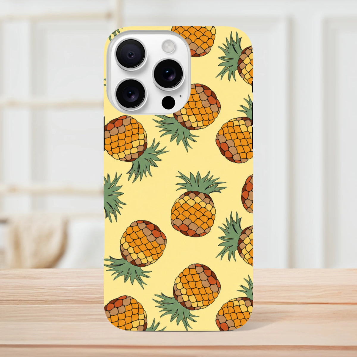 Yellow pineapple tough iPhone case featuring a tropical print pattern on a pastel yellow background for impact protection.