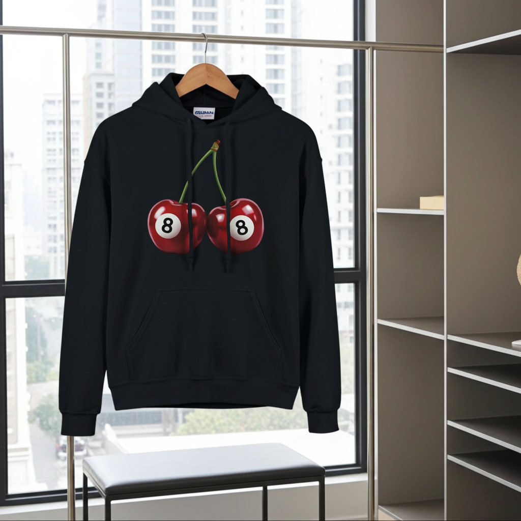 Black hoodie with cherry design on a hanger in a room with large windows.