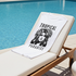 White T-Shirt with 'Tropical Paradise' design on a lounge chair by a pool