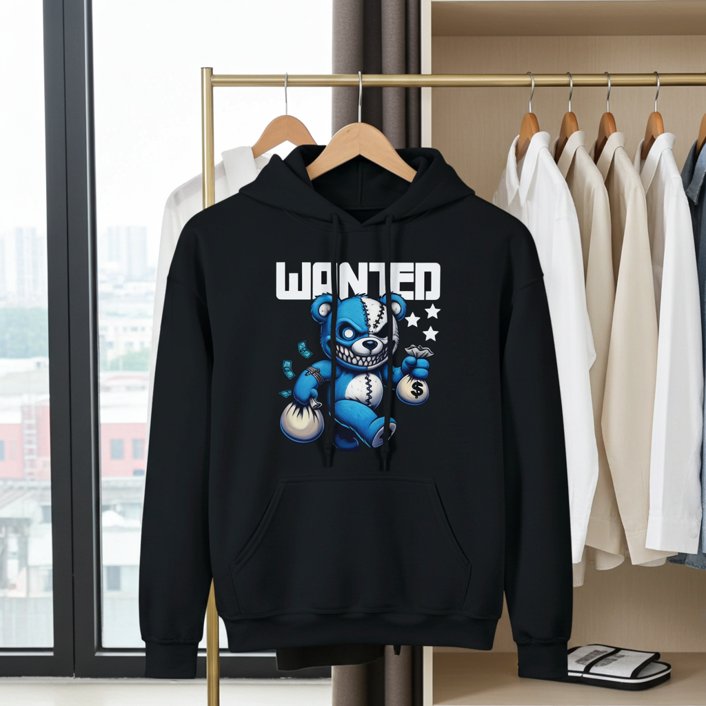 Black hoodie with a graphic design of a bear and text 'WANTED' on a rack with other clothes.