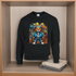 Black sweatshirt with a colorful bear graphic on a wooden shelf