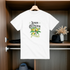 White t-shirt with lemon-themed design hanging in a wardrobe.