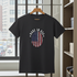 Black t-shirt with 'Made in USA' graphic on a hanger in a room with a window view.