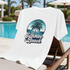 White T-Shirt with 'Summer Beach' design draped over a lounge chair by a pool.