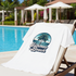 White t-shirt with 'Summer Beach' design on a lounge chair by a pool