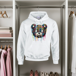White hoodie with a colorful bear design hanging in a wardrobe.