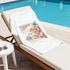 White T-Shirt with a tequila-themed design on a lounge chair by a pool.