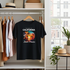 Black t-shirt with 'The Best of California Beach Paradise' design on a hanger in a room with clothes and decor.