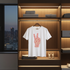 White t-shirt with red graphic design hanging on a wooden shelf in a modern closet.