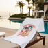 White T-Shirt with 'Summer Vibes Sunshine & Palm Trees' design on a lounge chair by a poolside.