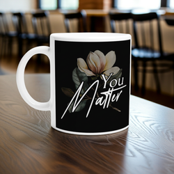 Mug with floral design and 'You Matter' text on a wooden table