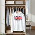 White hoodie with British flag design hanging in a wardrobe.