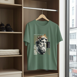 Green t-shirt with graphic design on a hanger in a wardrobe.
