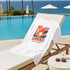 White T-Shirt with 'Aloha Hawaii Paradise Island' design on a lounge chair by a pool with ocean view.