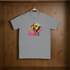 Gray t-shirt with a colorful dog graphic on a wooden surface